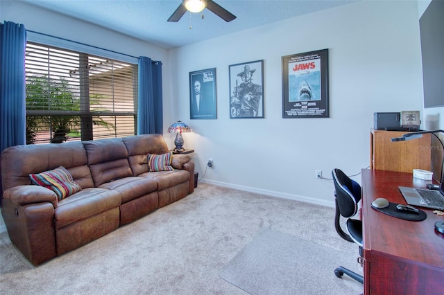 carpeted office featuring a textured ceiling and ceiling fan