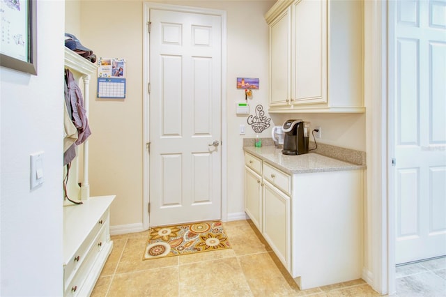 kitchen with light stone counters and light tile patterned floors