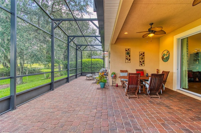 sunroom / solarium featuring ceiling fan