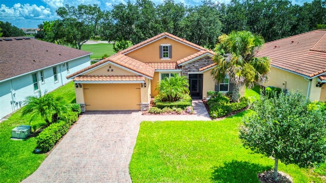 mediterranean / spanish home featuring a front lawn