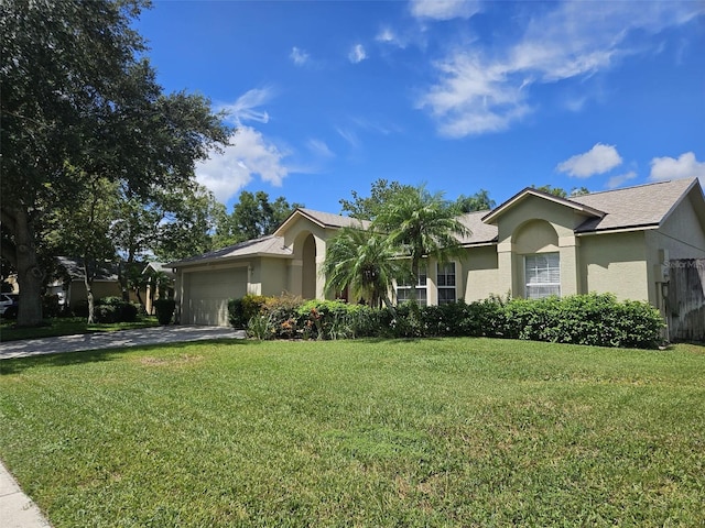 ranch-style home featuring a garage and a front lawn