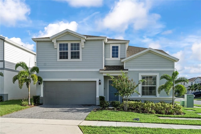 view of front of property featuring a front yard and a garage