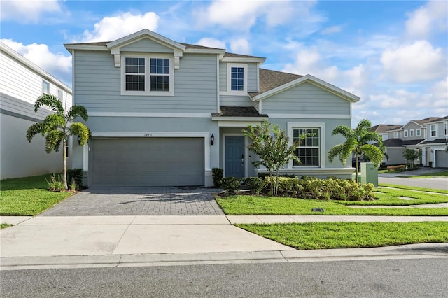 view of front of home with a garage and a front yard