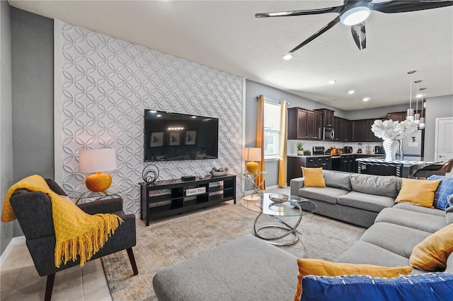 tiled living room featuring a textured ceiling and ceiling fan with notable chandelier