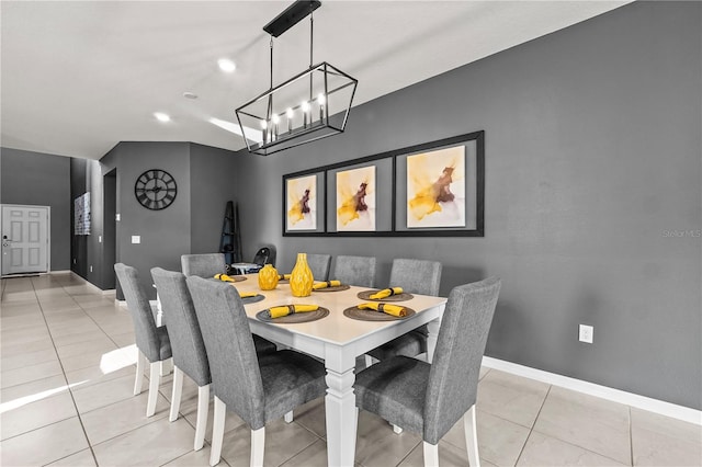 tiled dining space featuring a chandelier