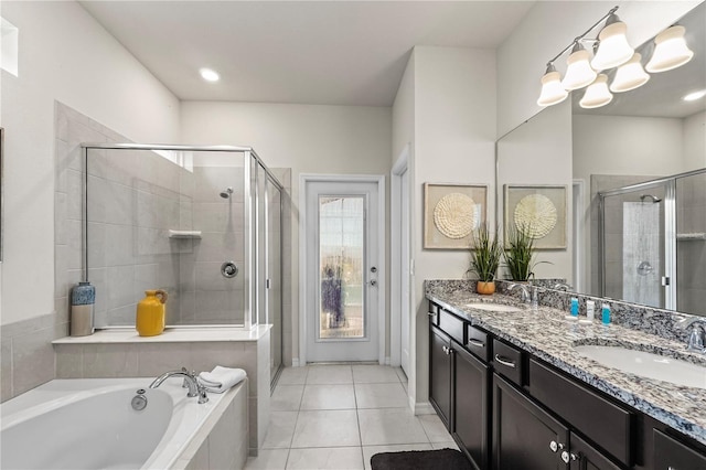 bathroom featuring vanity, an inviting chandelier, separate shower and tub, and tile patterned floors