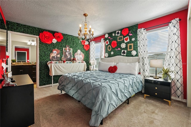 bedroom featuring a textured ceiling, connected bathroom, a notable chandelier, and carpet floors