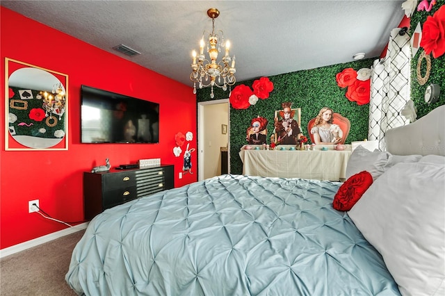 bedroom with an inviting chandelier, a textured ceiling, and carpet floors