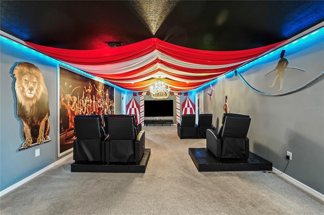 carpeted cinema with a notable chandelier