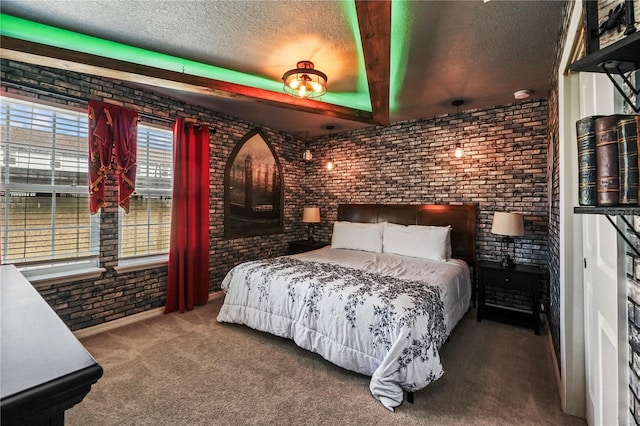 carpeted bedroom with a textured ceiling and brick wall