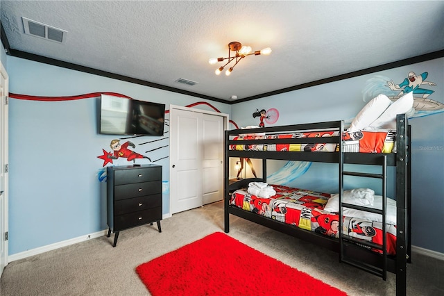 carpeted bedroom featuring a textured ceiling, crown molding, and an inviting chandelier