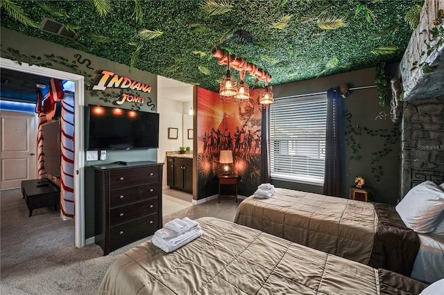 bedroom with a fireplace, connected bathroom, and light colored carpet