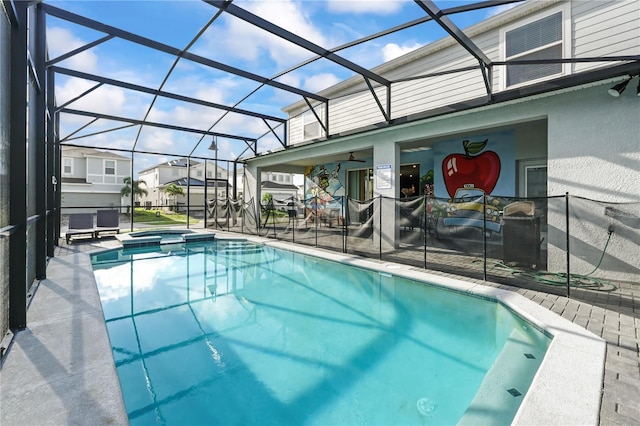 view of pool with a patio area and glass enclosure