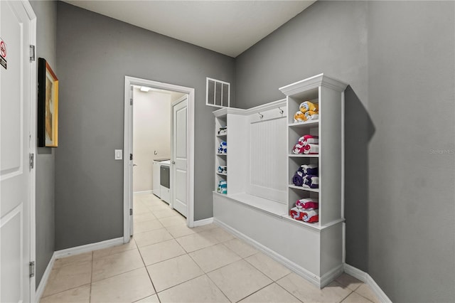 mudroom featuring washer / dryer and light tile patterned flooring