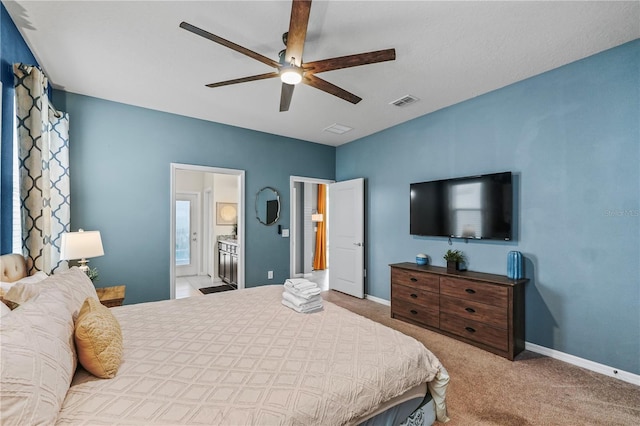 carpeted bedroom featuring ceiling fan and ensuite bathroom