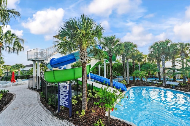 view of swimming pool with a water slide