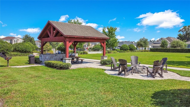 view of home's community with a yard, an outdoor fire pit, and a gazebo