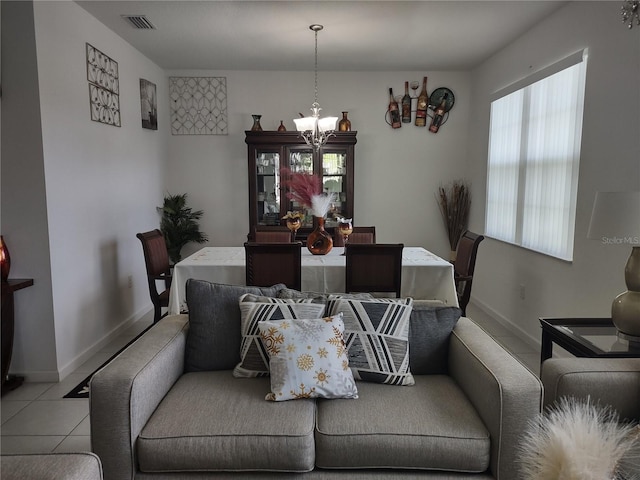 dining room featuring a wealth of natural light, light tile patterned floors, and a notable chandelier