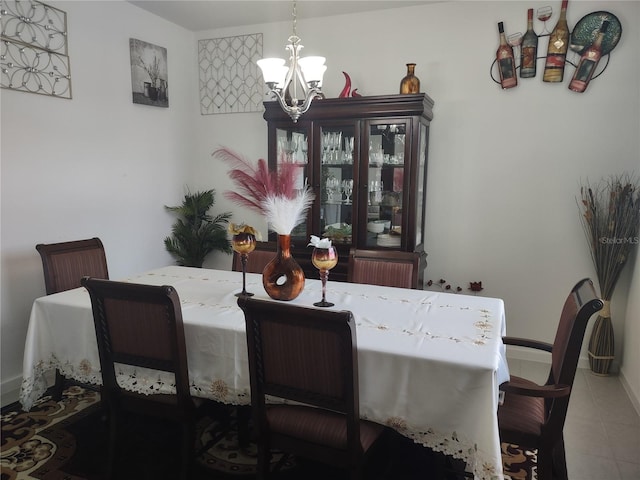 tiled dining space with a notable chandelier