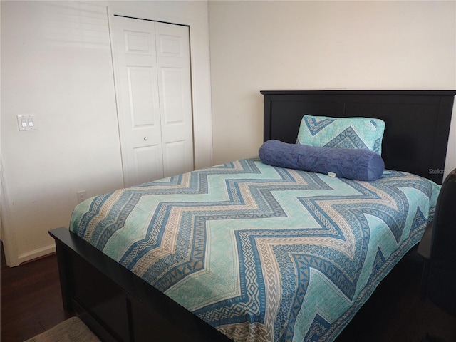 bedroom featuring hardwood / wood-style floors and a closet