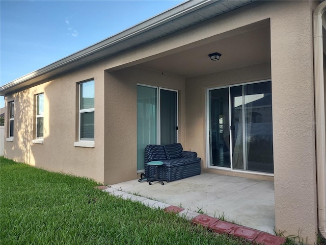 back of property featuring a yard and a patio