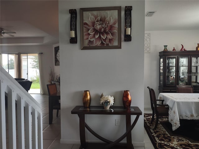 interior space with ceiling fan and tile patterned floors