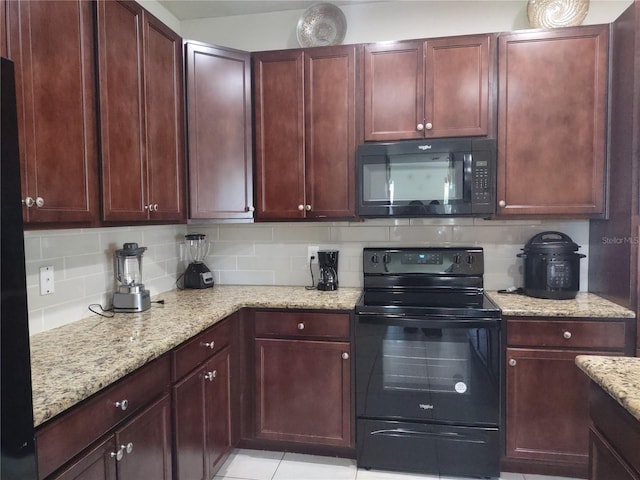 kitchen with black appliances, light tile patterned flooring, backsplash, and light stone countertops