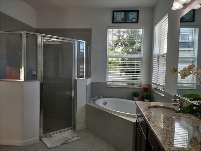 bathroom featuring vanity, a healthy amount of sunlight, and shower with separate bathtub