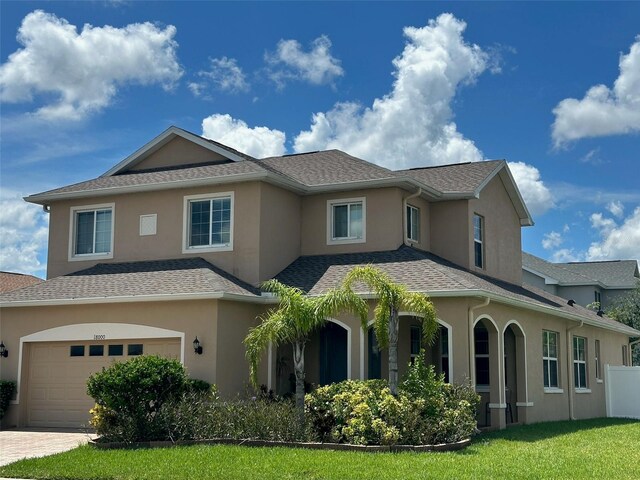 view of front of home with a garage and a front yard