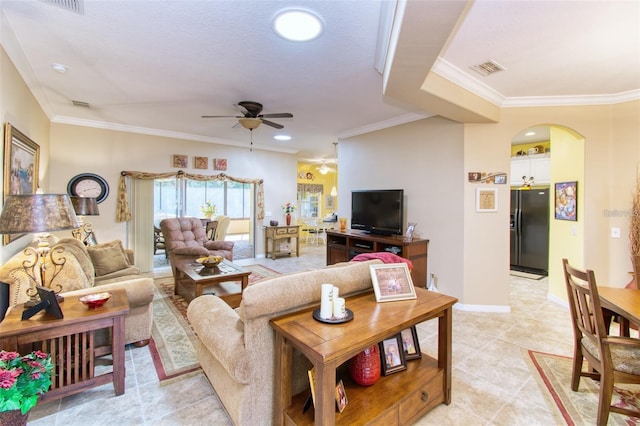 tiled living room featuring ceiling fan, crown molding, and a textured ceiling