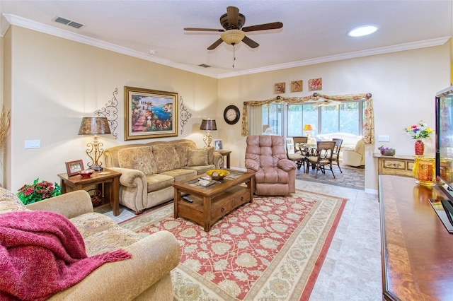 living room with ceiling fan, crown molding, and light tile patterned flooring