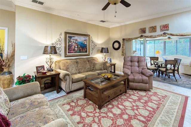 living room with ceiling fan, light tile patterned flooring, and ornamental molding