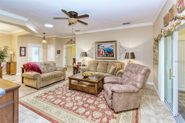 tiled living room with ceiling fan and ornamental molding