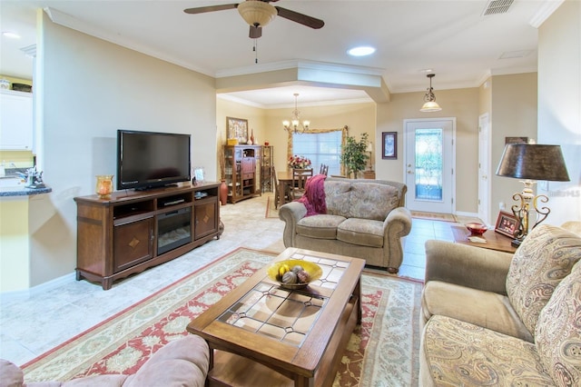 tiled living room with ceiling fan with notable chandelier and ornamental molding