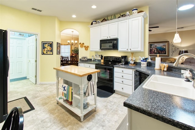 kitchen with white cabinets, sink, decorative light fixtures, kitchen peninsula, and black appliances