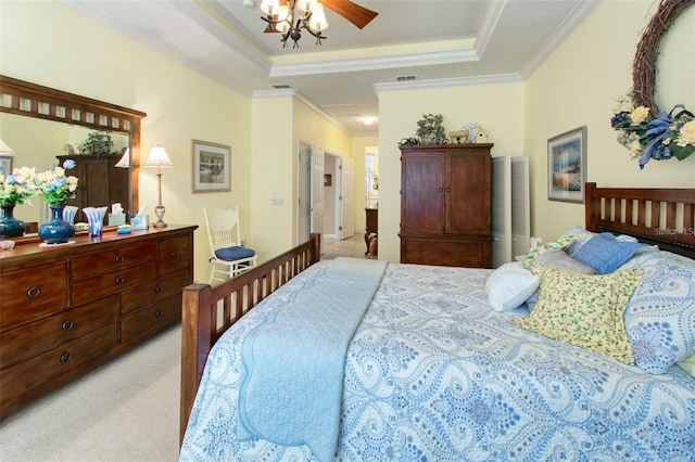 bedroom featuring ceiling fan, carpet floors, crown molding, and a tray ceiling