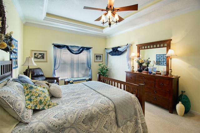 carpeted bedroom featuring a textured ceiling, ceiling fan, a raised ceiling, and crown molding