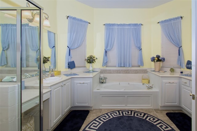 bathroom with a bath, tile patterned flooring, and vanity