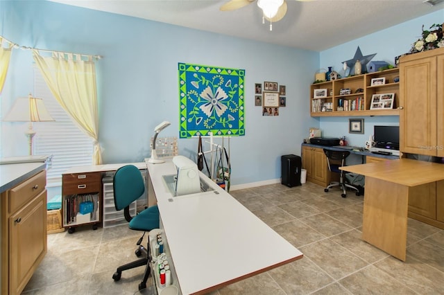 tiled home office featuring ceiling fan