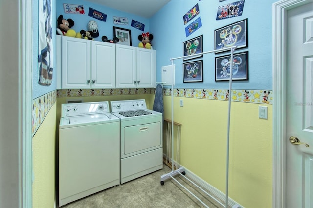 washroom featuring independent washer and dryer, light tile patterned flooring, and cabinets