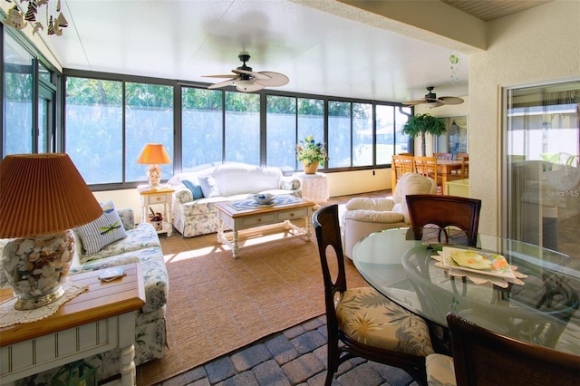 sunroom / solarium featuring ceiling fan