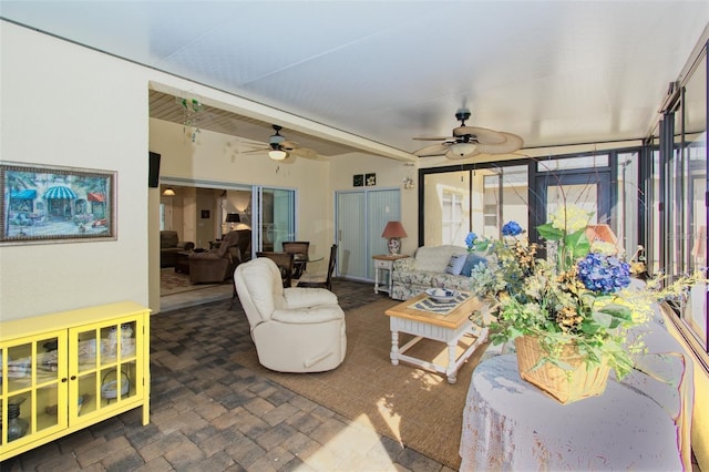 tiled living room featuring ceiling fan