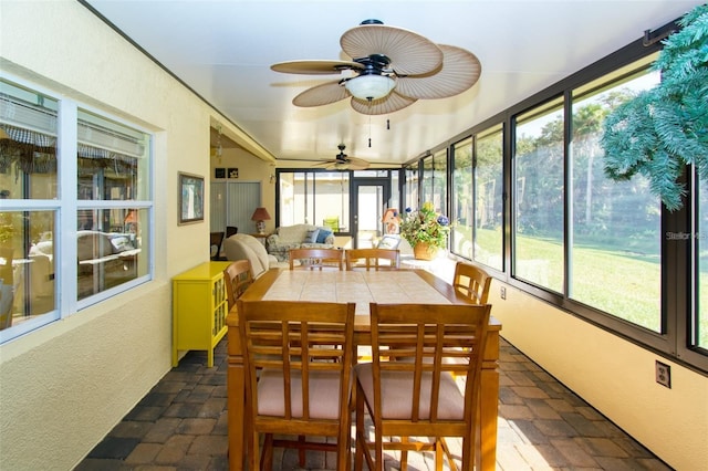 sunroom / solarium featuring ceiling fan