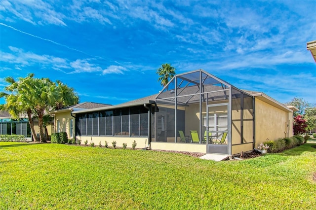 rear view of property with a lawn