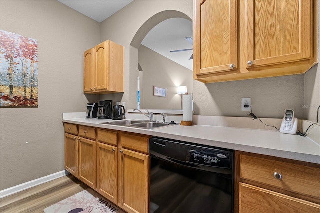7671 Comrow St Unit 202, Kissimmee, FL 34747 - kitchen featuring dishwasher, a sink, arched walkways, light wood-style floors, and light countertops