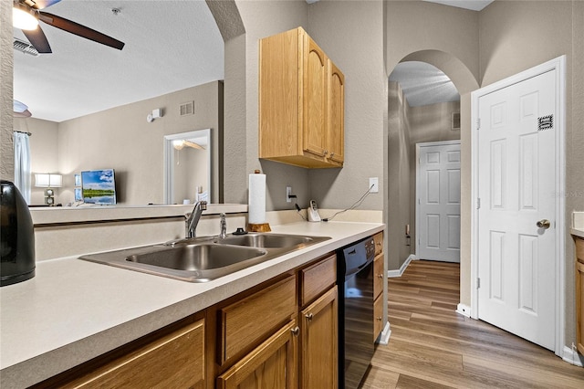 7671 Comrow St Unit 202, Kissimmee, FL 34747 - kitchen featuring dishwasher, a sink, a ceiling fan, arched walkways, and wood finished floors