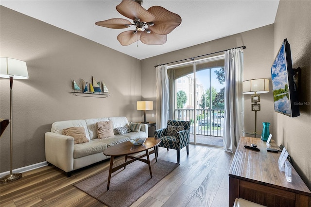 living room featuring ceiling fan and hardwood / wood-style flooring