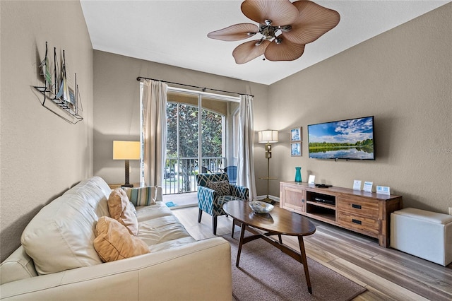 7671 Comrow St Unit 202, Kissimmee, FL 34747 - living room featuring wood finished floors, ceiling fan, and a textured wall