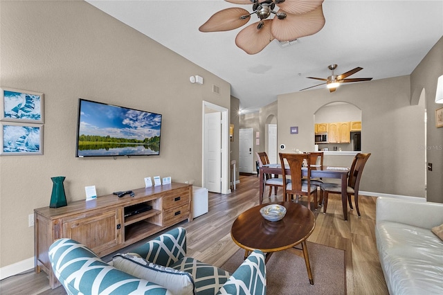 living room featuring light hardwood / wood-style flooring and ceiling fan