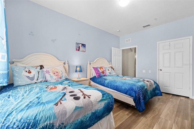 bedroom with hardwood / wood-style floors